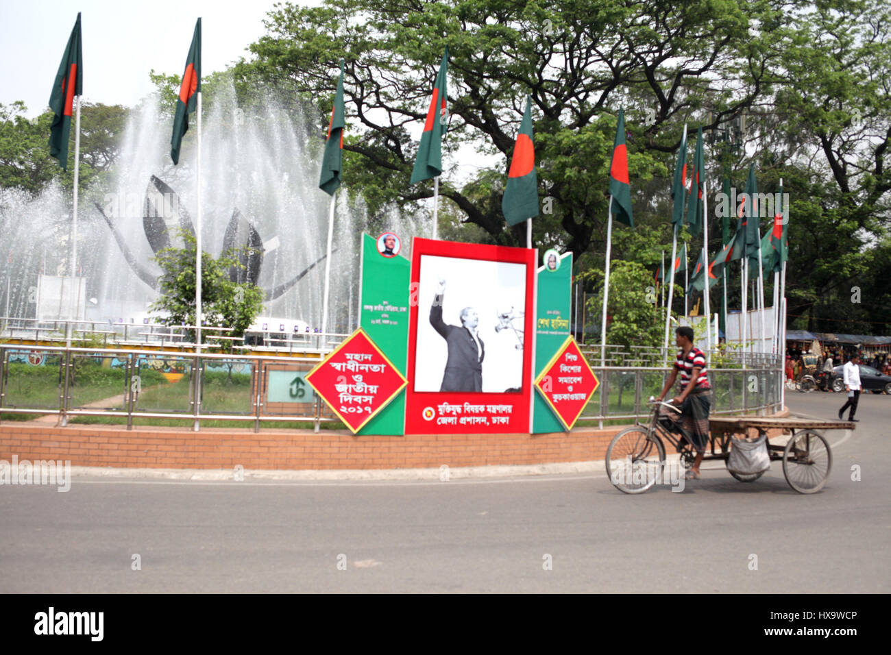 Dhaka, Bangladesh. 26th Mar, 2017. 26 March 2017 Dhaka, Bangladesh ''“ Bangladeshi rickshwa van puller ride his rickshea van on the road during the nation to celebrate 46 Independence Day on 26 March 2017 Dhaka, Bangladesh. In 1971 when the Pakistani occupation forces kicked off one of the worst genocides in history that led to a nine-month war for the independence of Bangladesh in 1971. © Monirul Alam Credit: Monirul Alam/ZUMA Wire/Alamy Live News Stock Photo