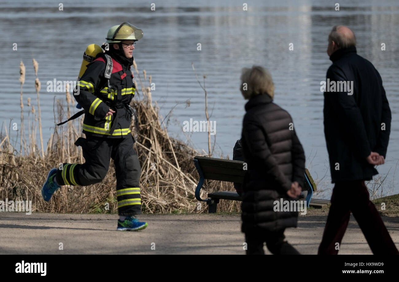 Hamburg, Germany. 26th Mar, 2017. Firefighter Max Plettenberg training for a marathon race along the Outer Alster in Hamburg, Germany, 26 March 2017. The firefighters gather donations for charitable projects with the run. Photo: Axel Heimken/dpa/Alamy Live News Stock Photo