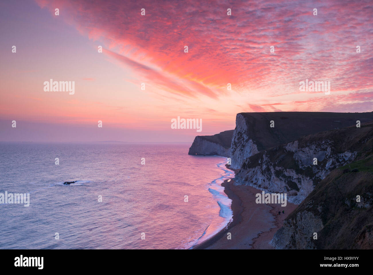 Lulworth, Dorset, UK. 26th March, 2017. UK Weather. Spectacular sunset above the chalk cliffs of Swyre Head and Bats Head, viewed from Durdle Door near Lulworth on the Dorset Jurassic Coast. Photo Credit: Graham Hunt/Alamy Live News Stock Photo