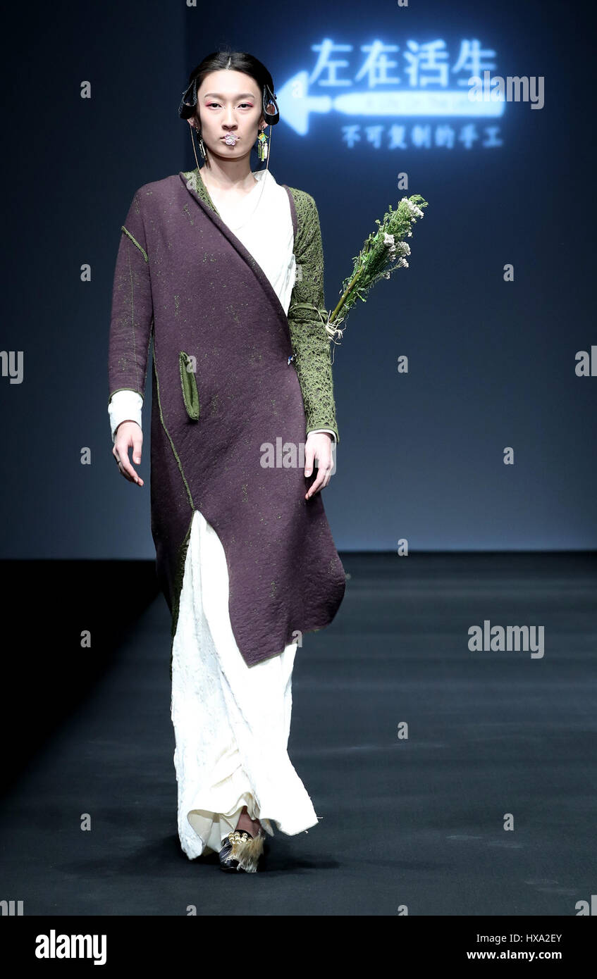 Beijing, China. 26th Mar, 2017. A model presents a creation by Lin Qi ...