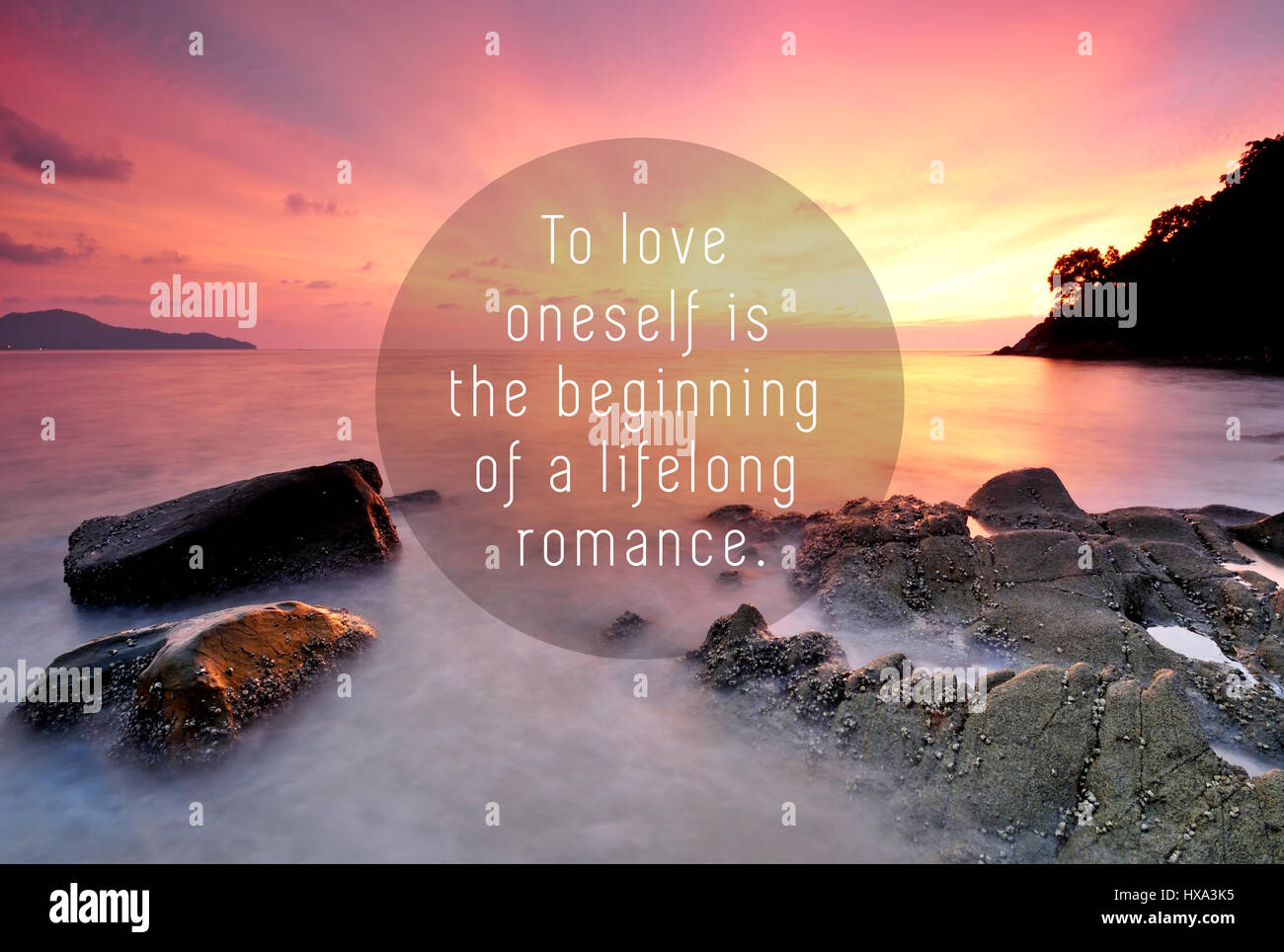 Inspirational quotes with phrase - to love oneself is the beginning of lifelong romance. Blurry sunset background. Stock Photo