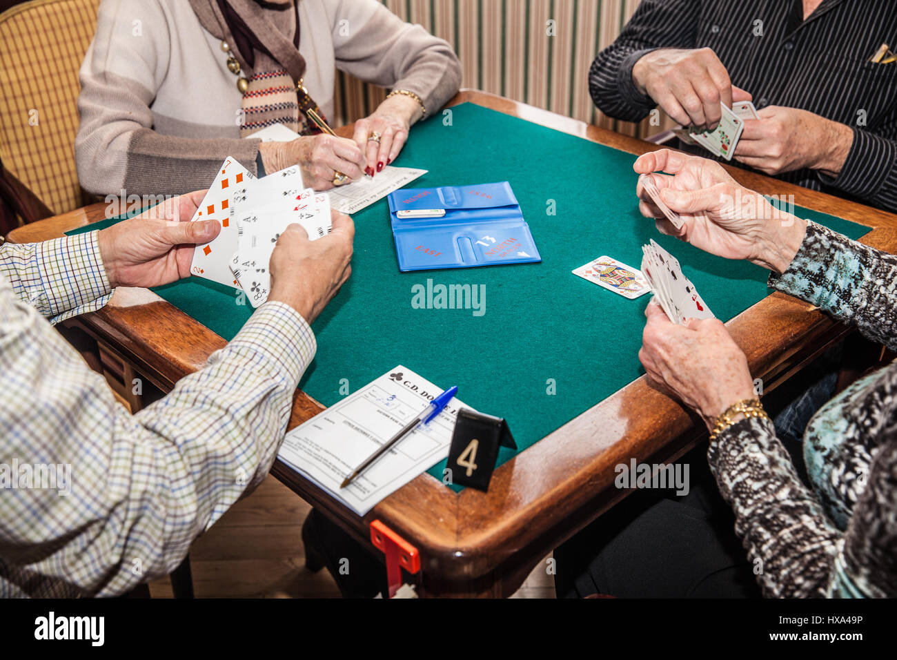 old people playing bridge game Stock Photo
