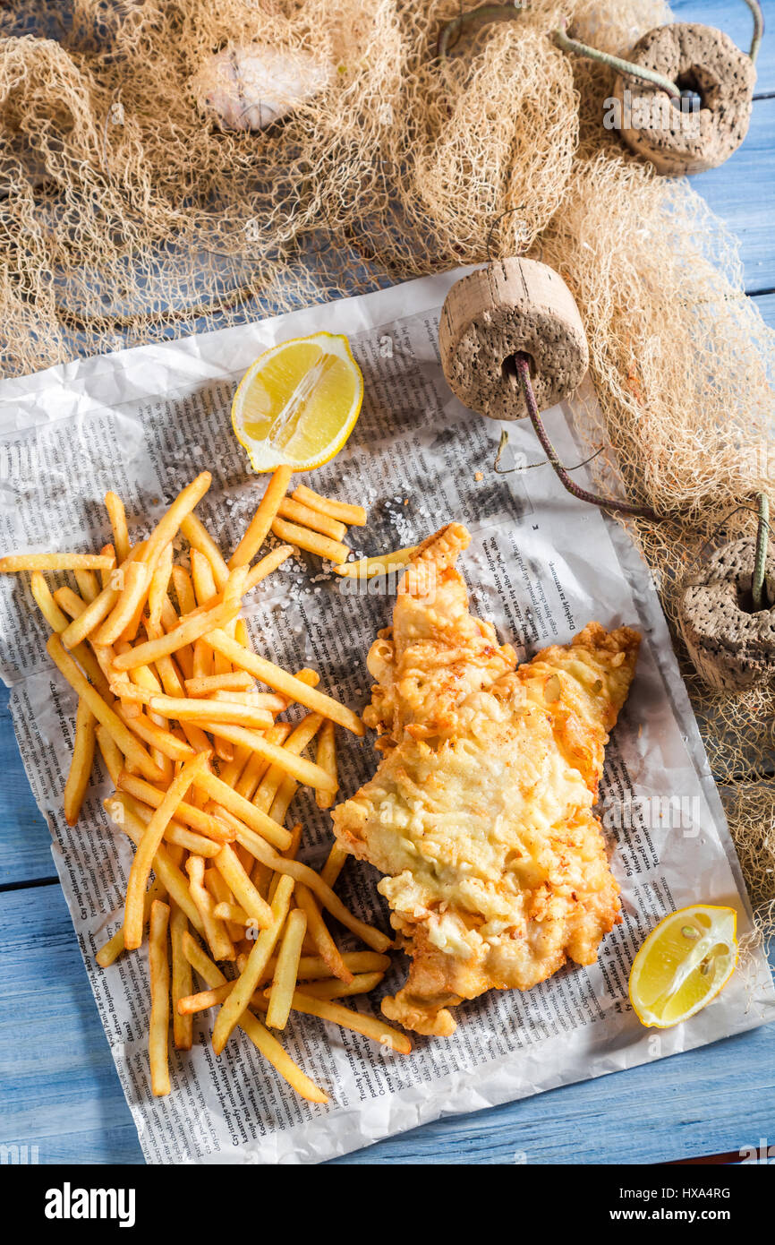 Tasty fish cod with chips in newspaper Stock Photo - Alamy