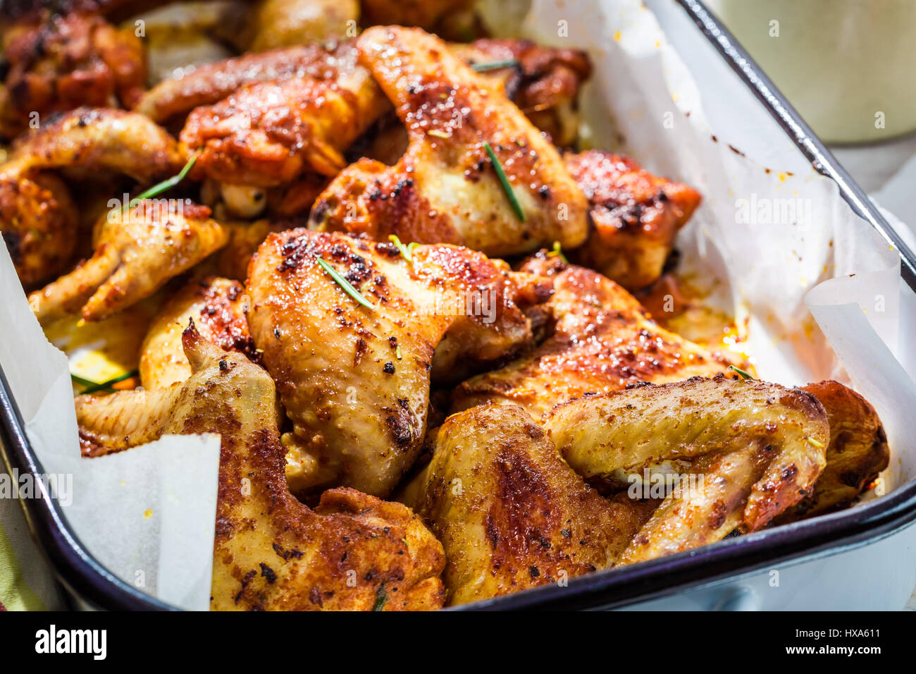 Tasty chicken wings with herbs and sauce Stock Photo - Alamy