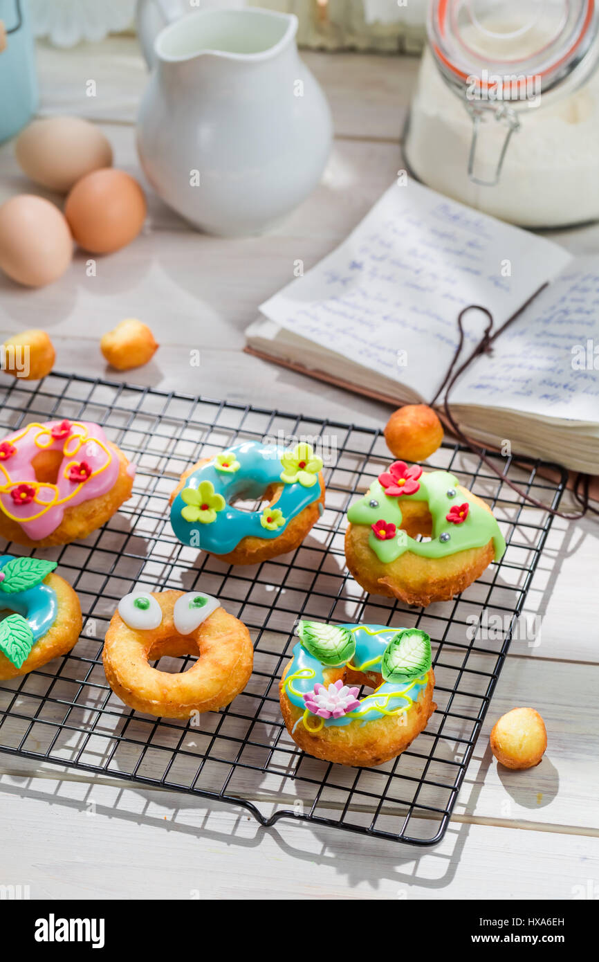 Glazed sweet and tasty donuts on old white table Stock Photo - Alamy