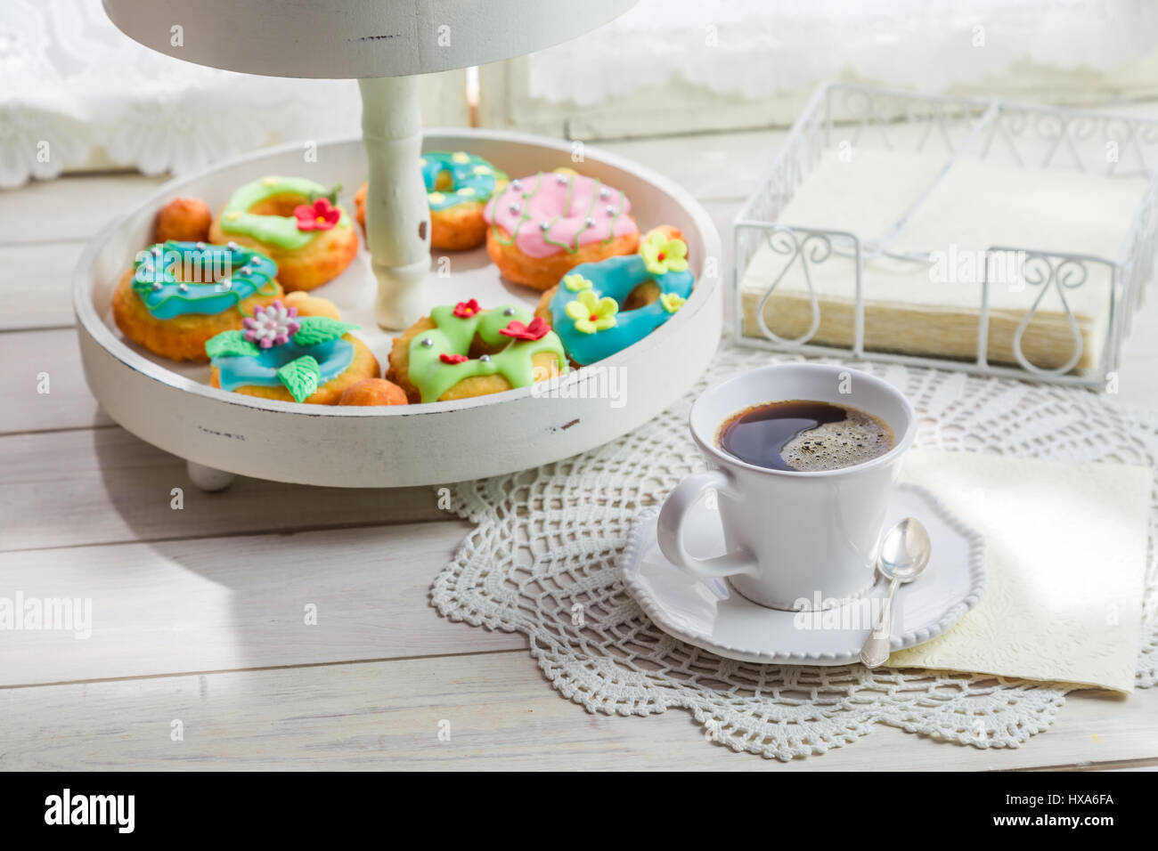 Tasty donuts served with coffee on old white table Stock Photo - Alamy