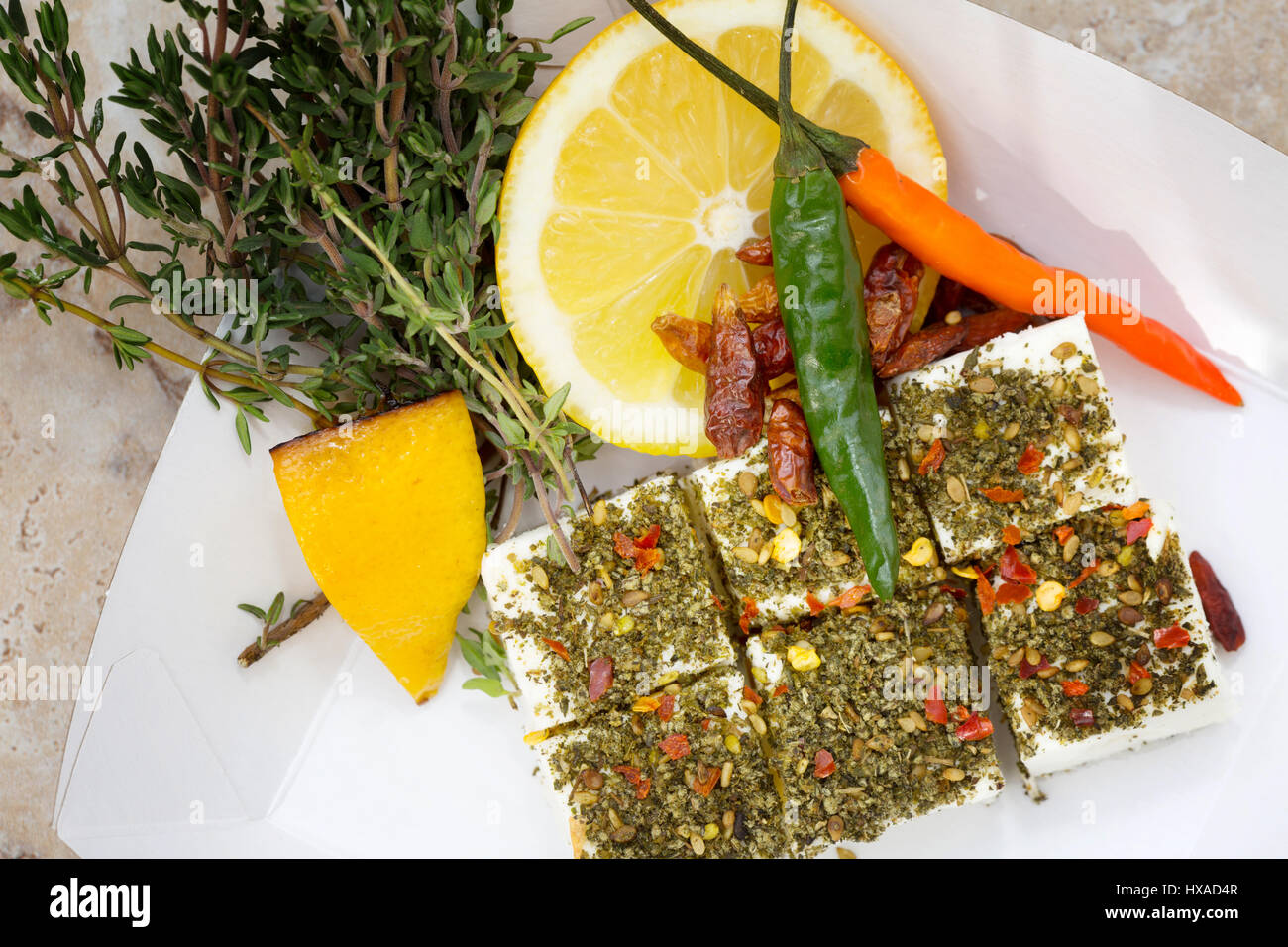 Vegetarian food - concept, healthy eating - a mezze dish of feta cheese, za'atar spices, lemon, chillies and thyme - middle eastern food influence Stock Photo