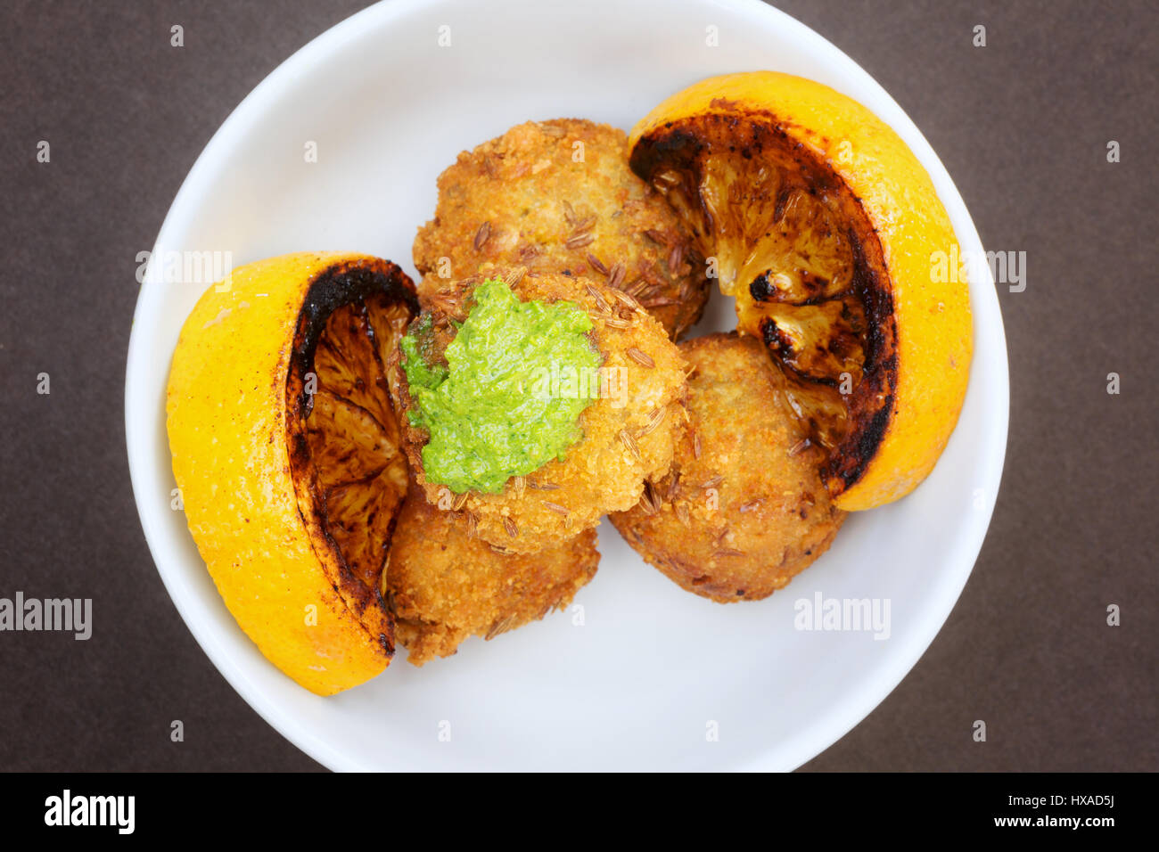 Healthy food - Butternut squash fritters with lemon and zough, example of vegetarian food and Vegan food, UK Stock Photo