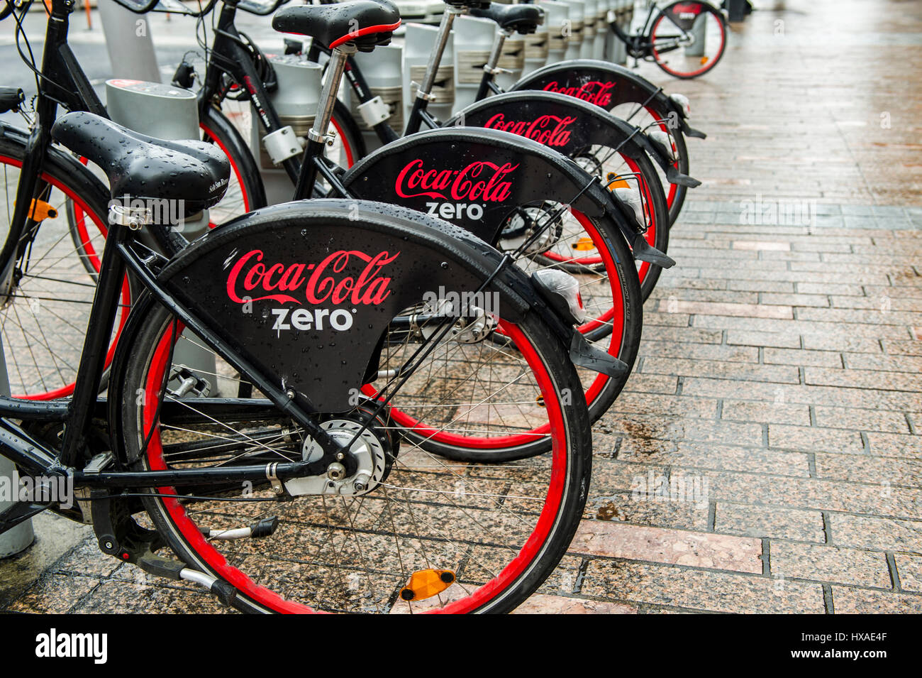 Coca Cola Zero bicycles in a row in a docking station as part of the community bike hire scheme in Cork, Ireland Stock Photo