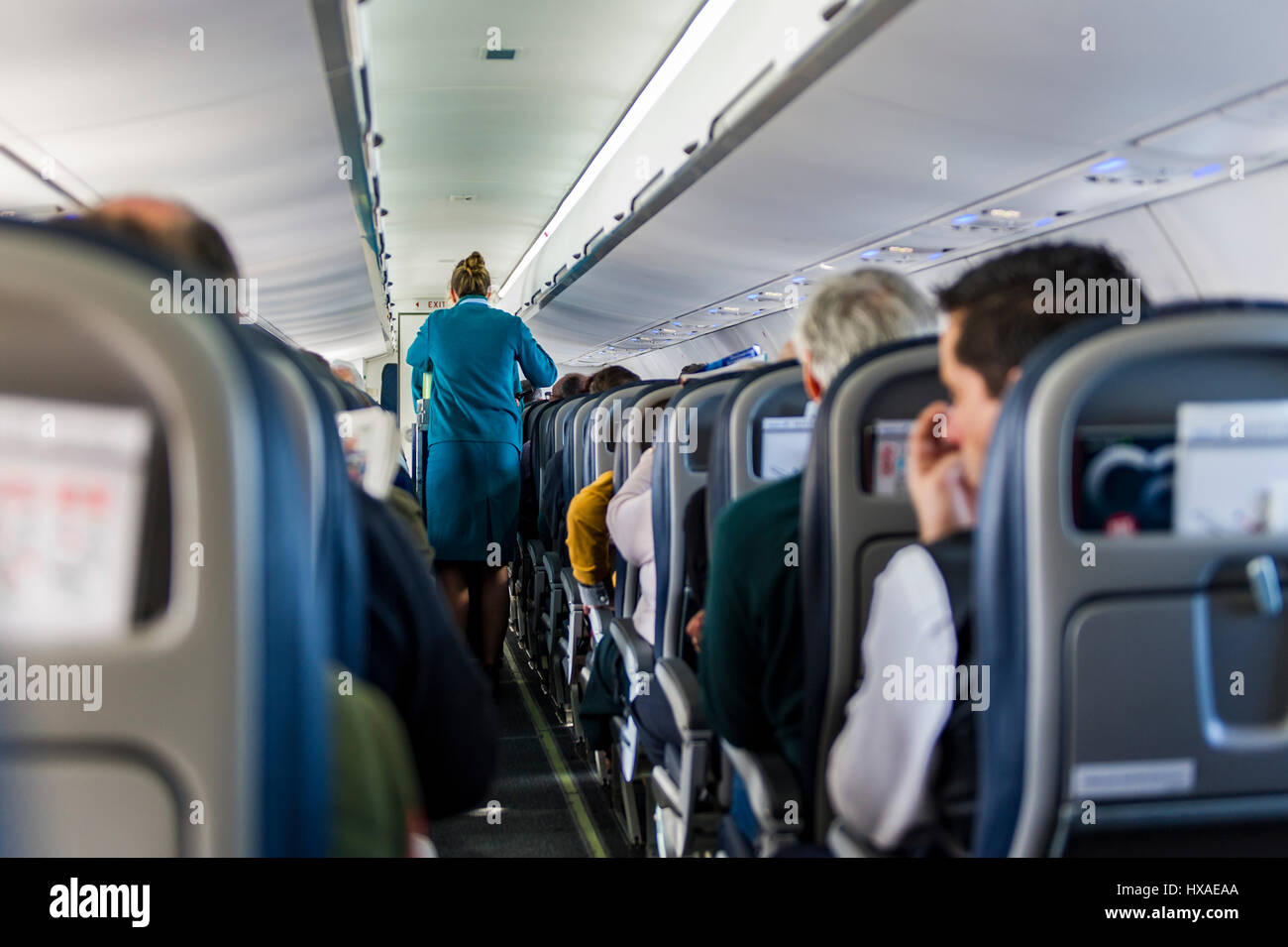 Aer Lingus stewardesses during service on a Birmingham (BHX) to Cork (ORK) regional flight aboard an ATR 72-600 propeller aircraft. Stock Photo