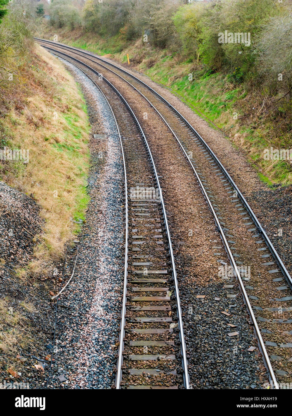 Two standard gauge railway lines on a curve in a cutting Stock Photo