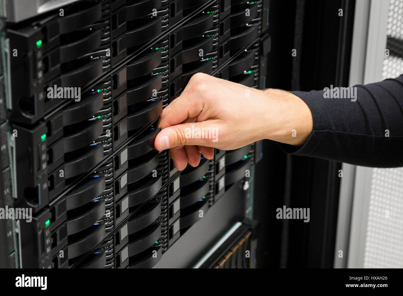 IT Engineer's Hand Replacing Hard Drive In Data Center Stock Photo
