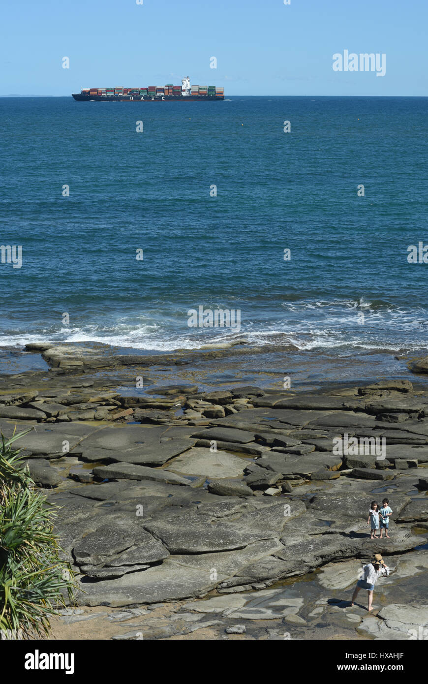 Sunshine Coast, Australia: A container ship outbound from Brisbane passes the rocky headland at Caloundra. Stock Photo