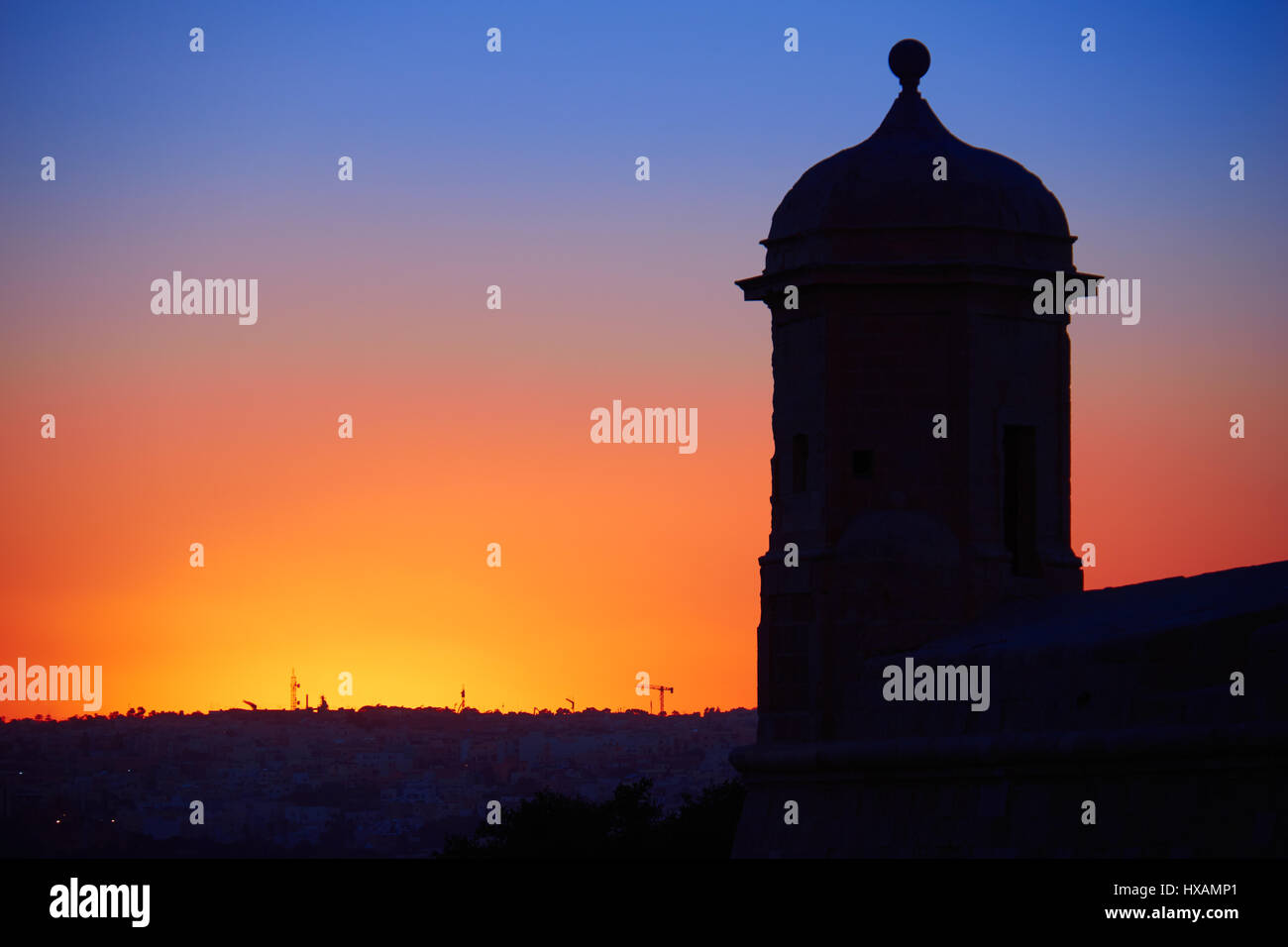 Night shot of The Guard tower on the tip of the St Peter and Paul counterguard against backlight of the sunset. Valletta, Malta Stock Photo