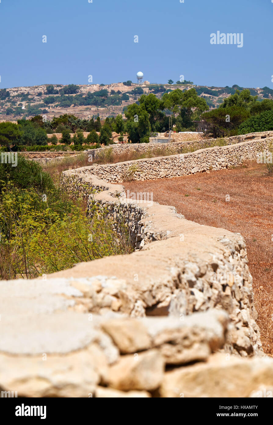 The stone fences stretch across the fields of scorched earth of Qrendi on Malta south coast. Stock Photo