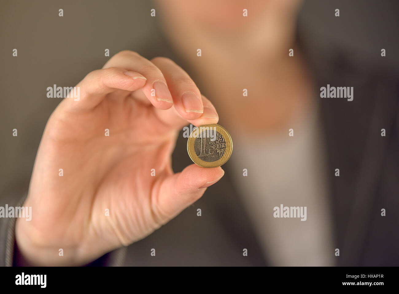 Businesswoman and one euro coin, business investment, money savings or financial trade concept, selective focus Stock Photo