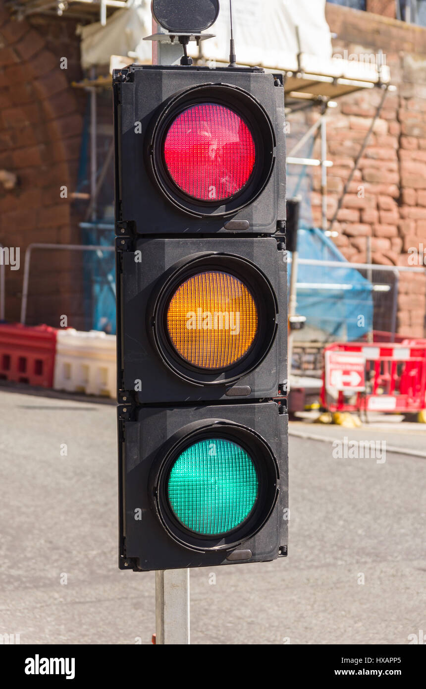 Confusing set of traffic lights showing red amber and green all at the same time can be used for concepts showing indecision mixed messages Stock Photo
