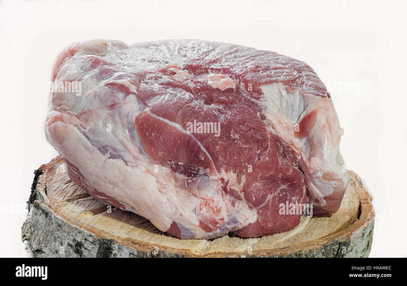Pork ham, a large piece of raw meat on a wooden Board made of birch on a  white background Stock Photo - Alamy