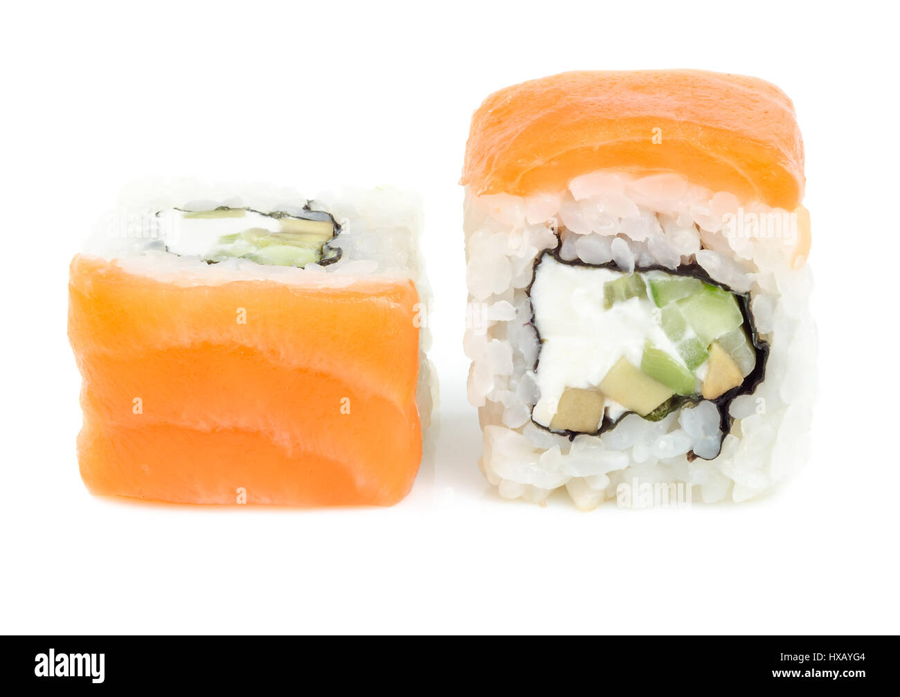 Asian Japanese food. Sushi rolls with salmon, cheese, avocado and cucumber. Close up front view isolated on white background. Stock Photo