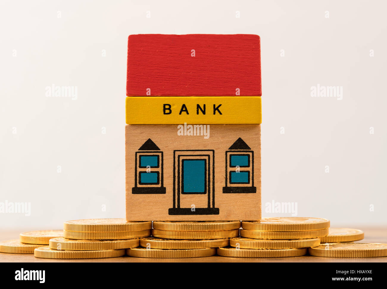 Toy bank building on gold coin assets Stock Photo