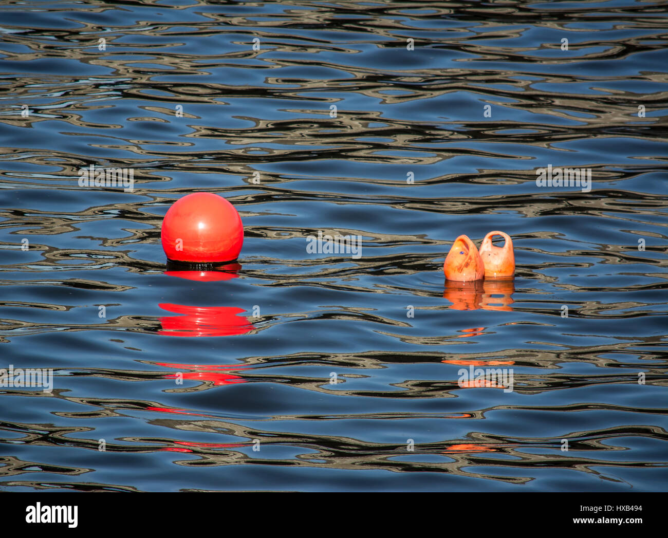 Small water buoys floating in the River Lagan, Belfast. Stock Photo
