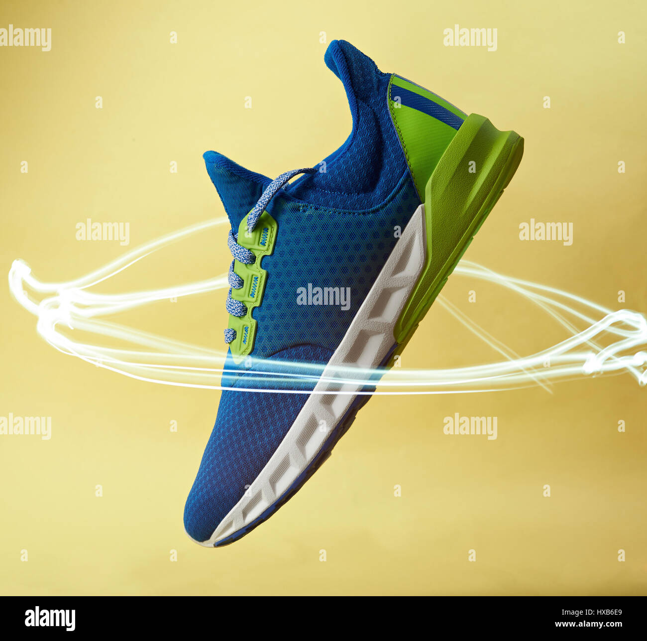 New modern running shoe in light circle on yellow background. Fast