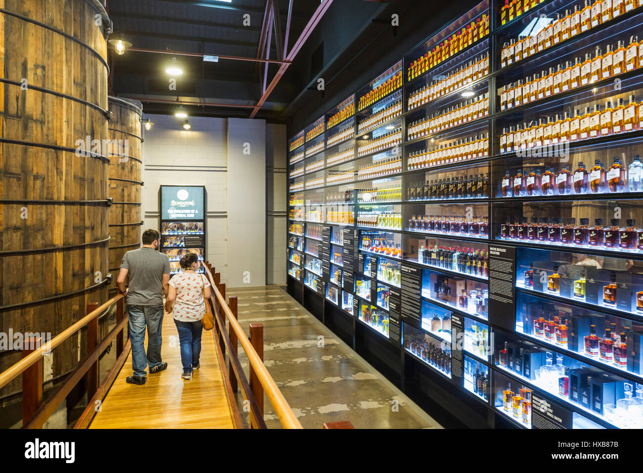 Visitors viewing the Wall of Bundy - a history of Bundaberg Rum products.  Bundaberg, Queensland, Australia Stock Photo