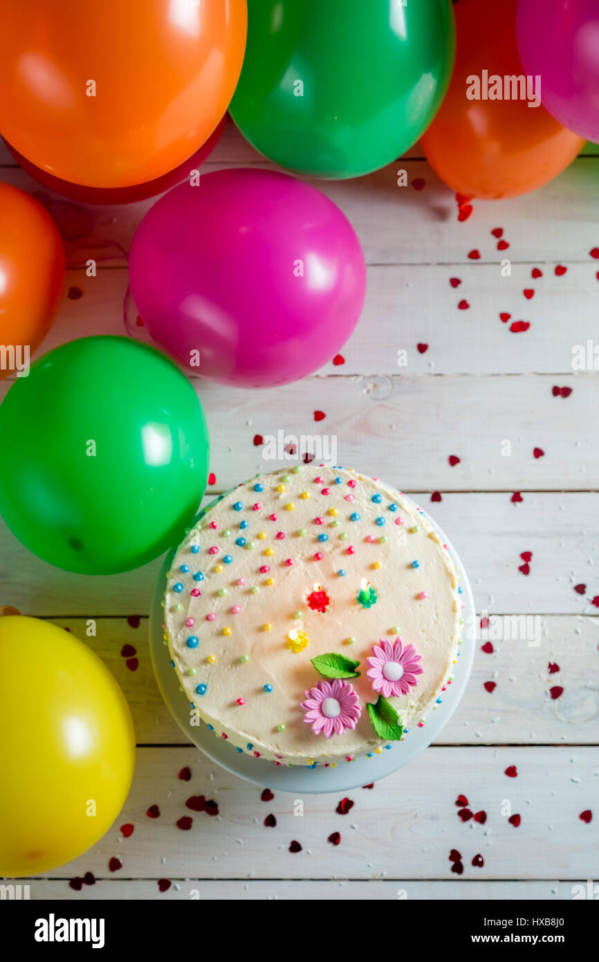 Beautifully decorated birthday cake with lighted candles Stock Photo