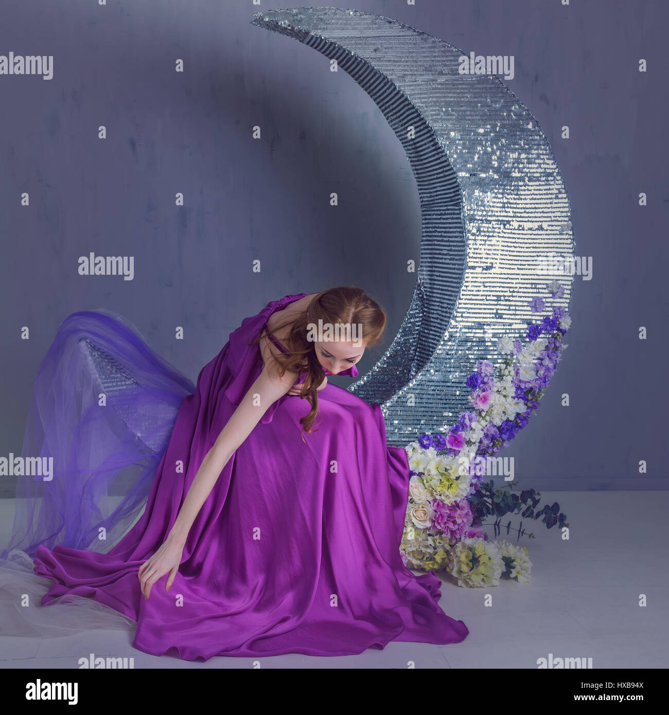 Cute girl dancer in a beautiful dress posing in the studio. Tinted ...