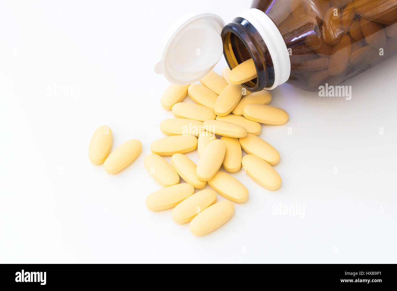 vitamin c pill and medicine bottle isolated on white background Stock