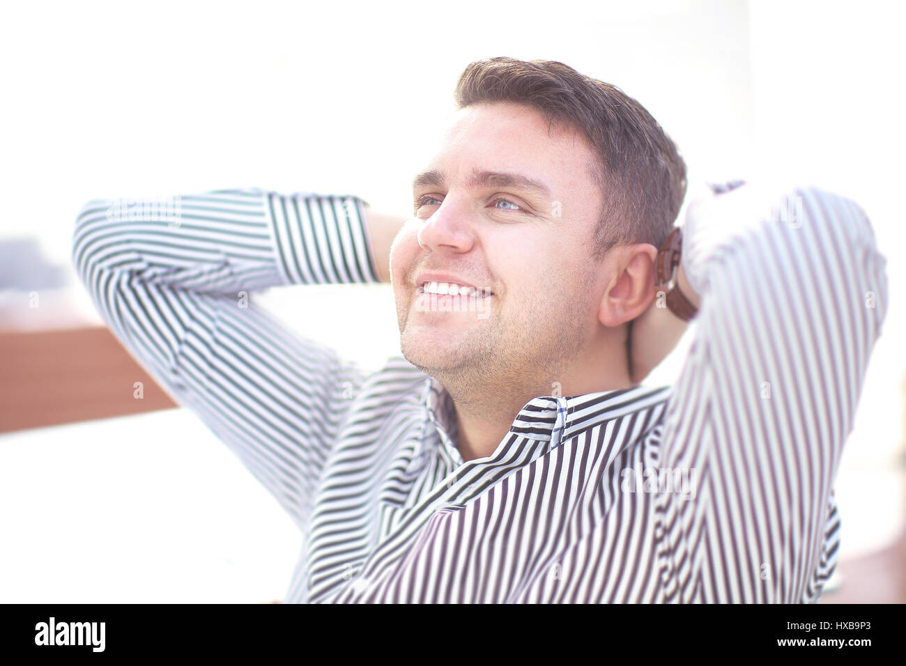 Successful young businessman posing and smiling at camera Stock Photo ...