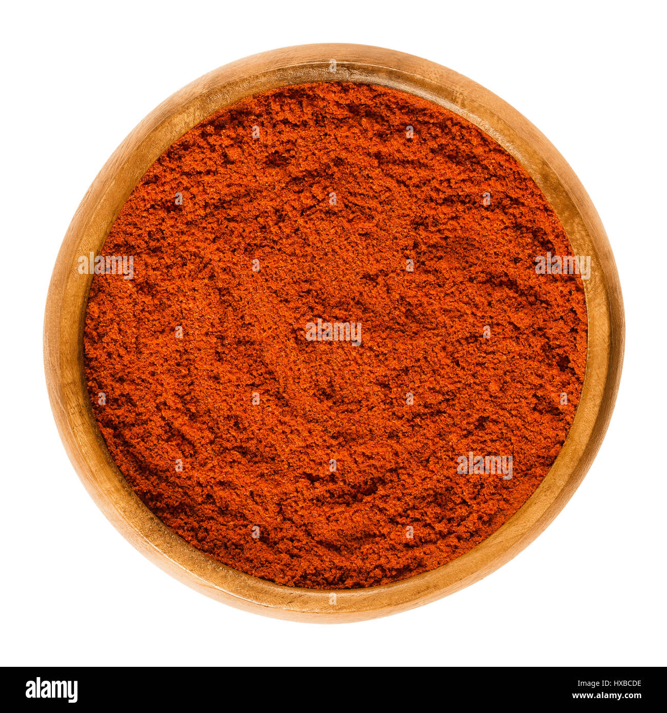 Sweet pepper red paprika powder in wooden bowl. Ground spice made from air-dried and smoked bell peppers, Capsicum annuum. Hungarian cuisine. Stock Photo
