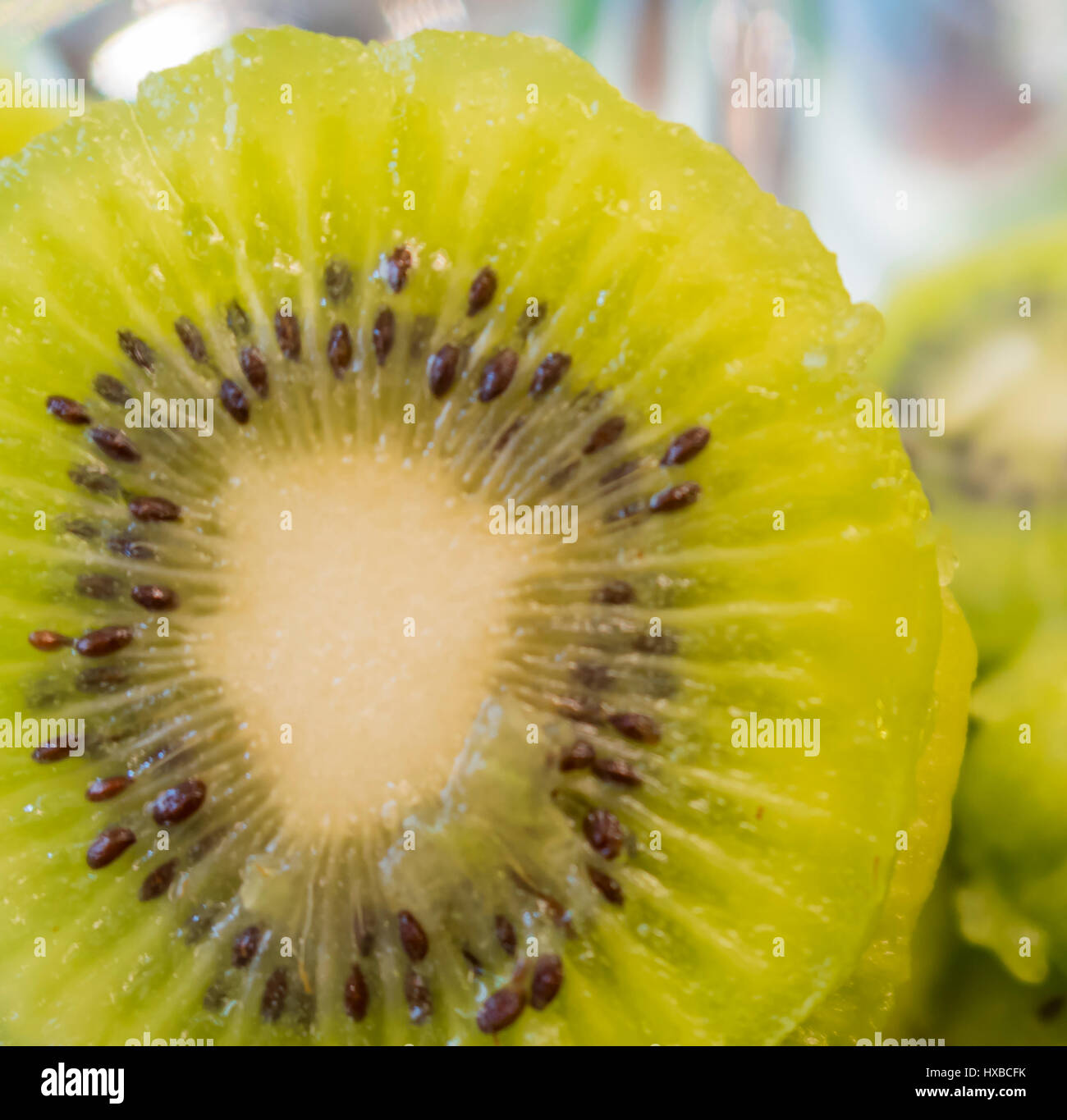 Slices of kiwi fruit on kiwi background Stock Photo