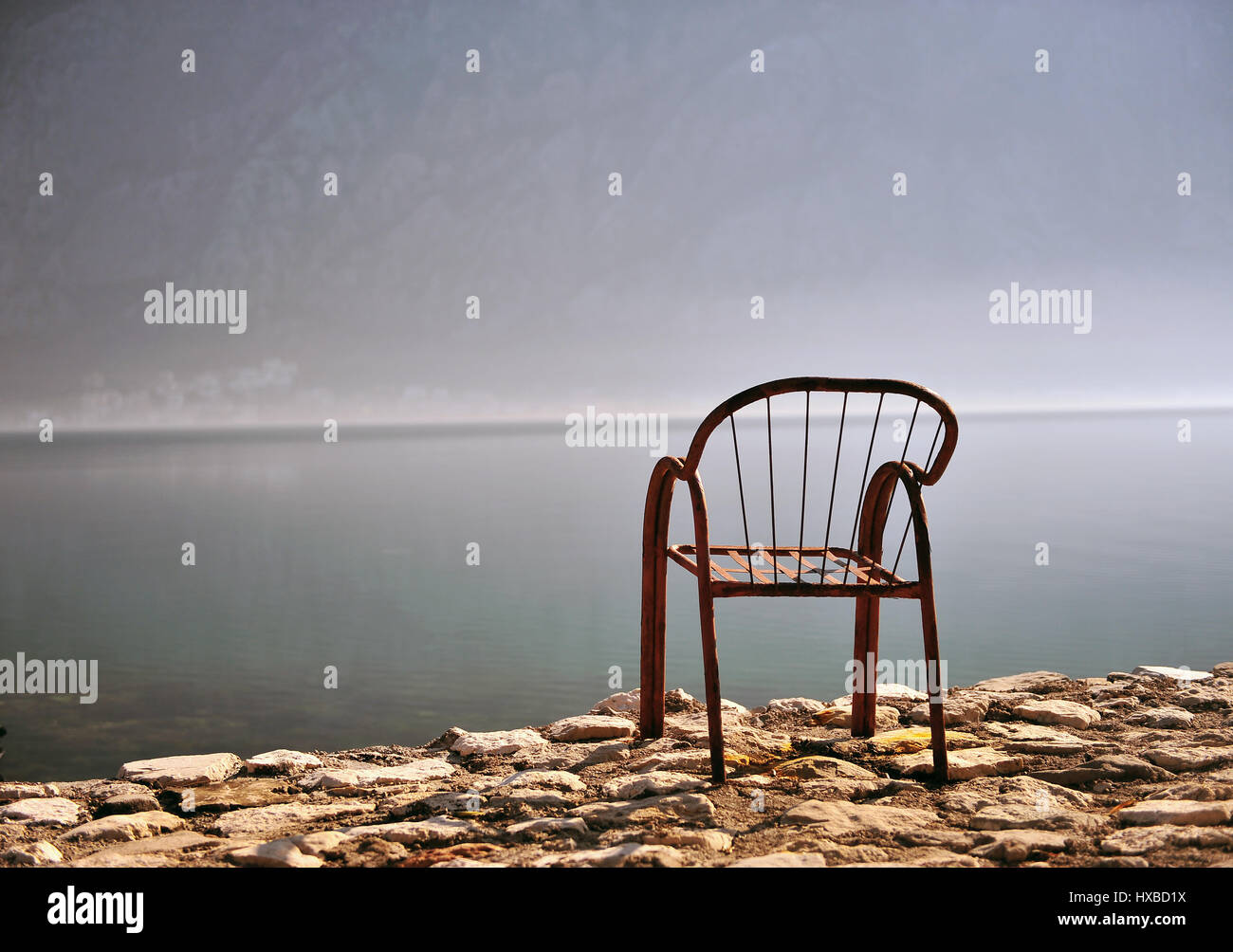 Empty chair at the sea on sunrise Stock Photo