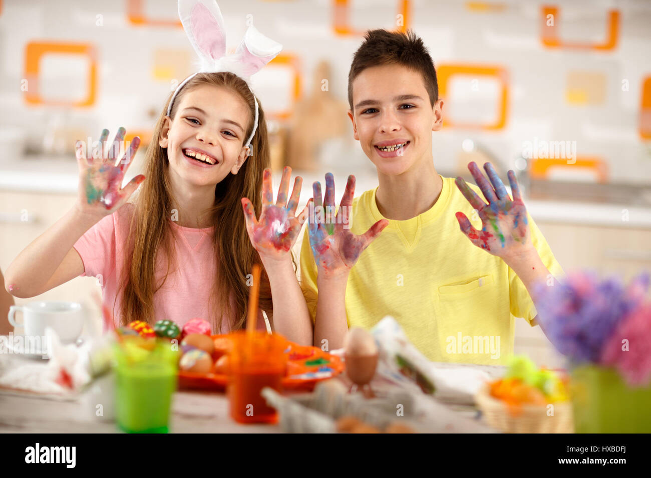 Cheerful children show colorful painted hands with paint for eggs Stock ...