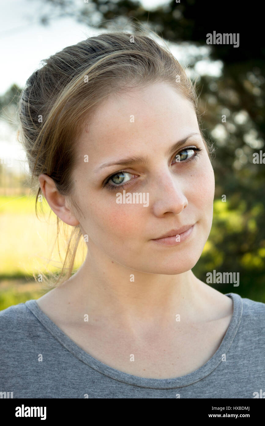 Portrait of a serious natural young woman outdoors Stock Photo