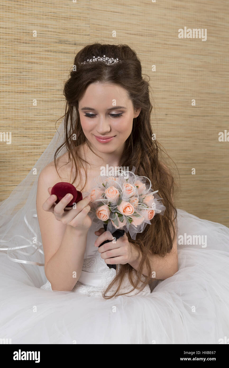 A charming bride is looking at an engagement ring. Stock Photo