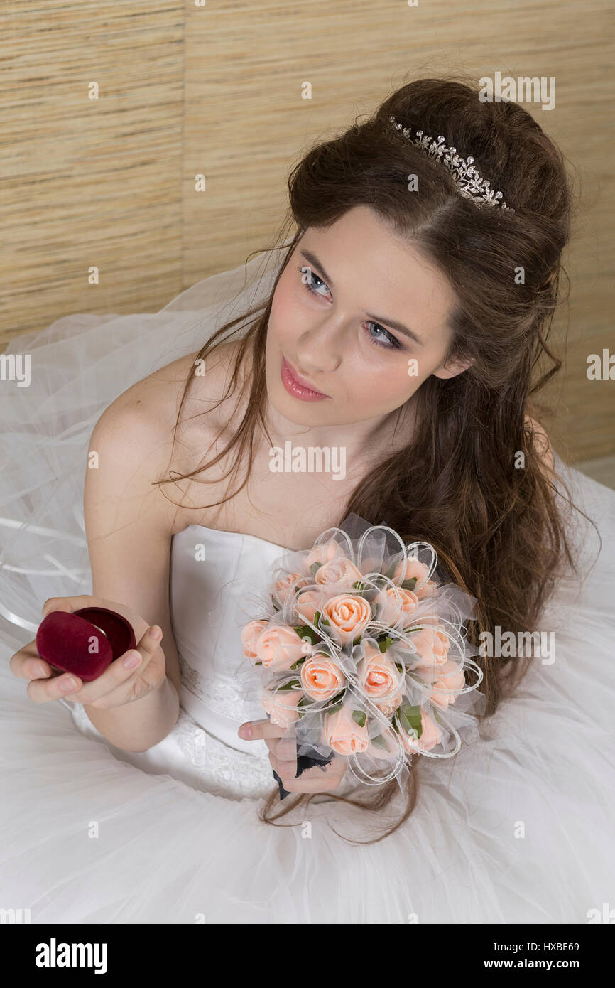 A charming bride is looking at an engagement ring. Stock Photo