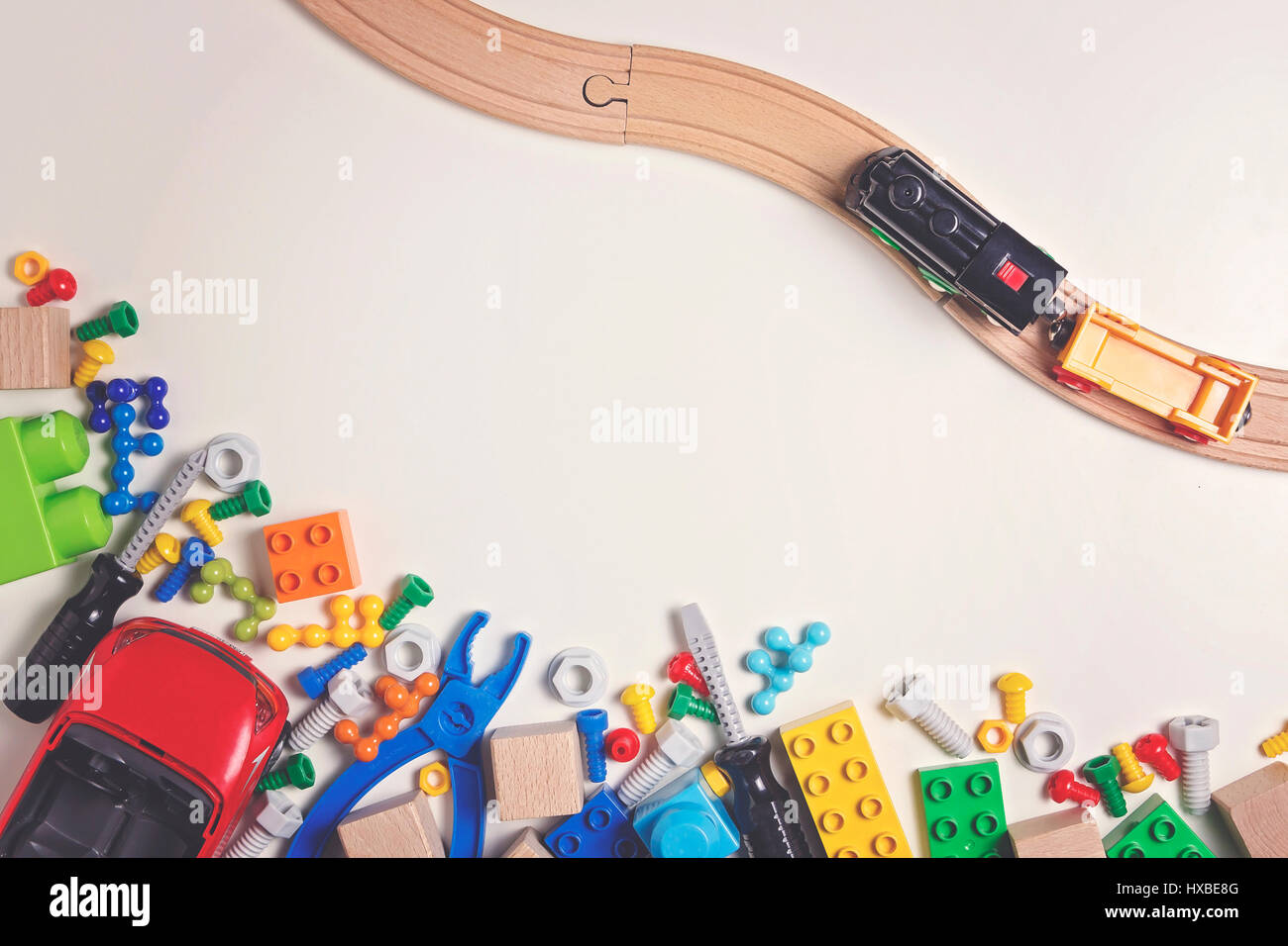 Colorful kids toys on white background as frame with copy space for text. Top view. Flat lay. Stock Photo