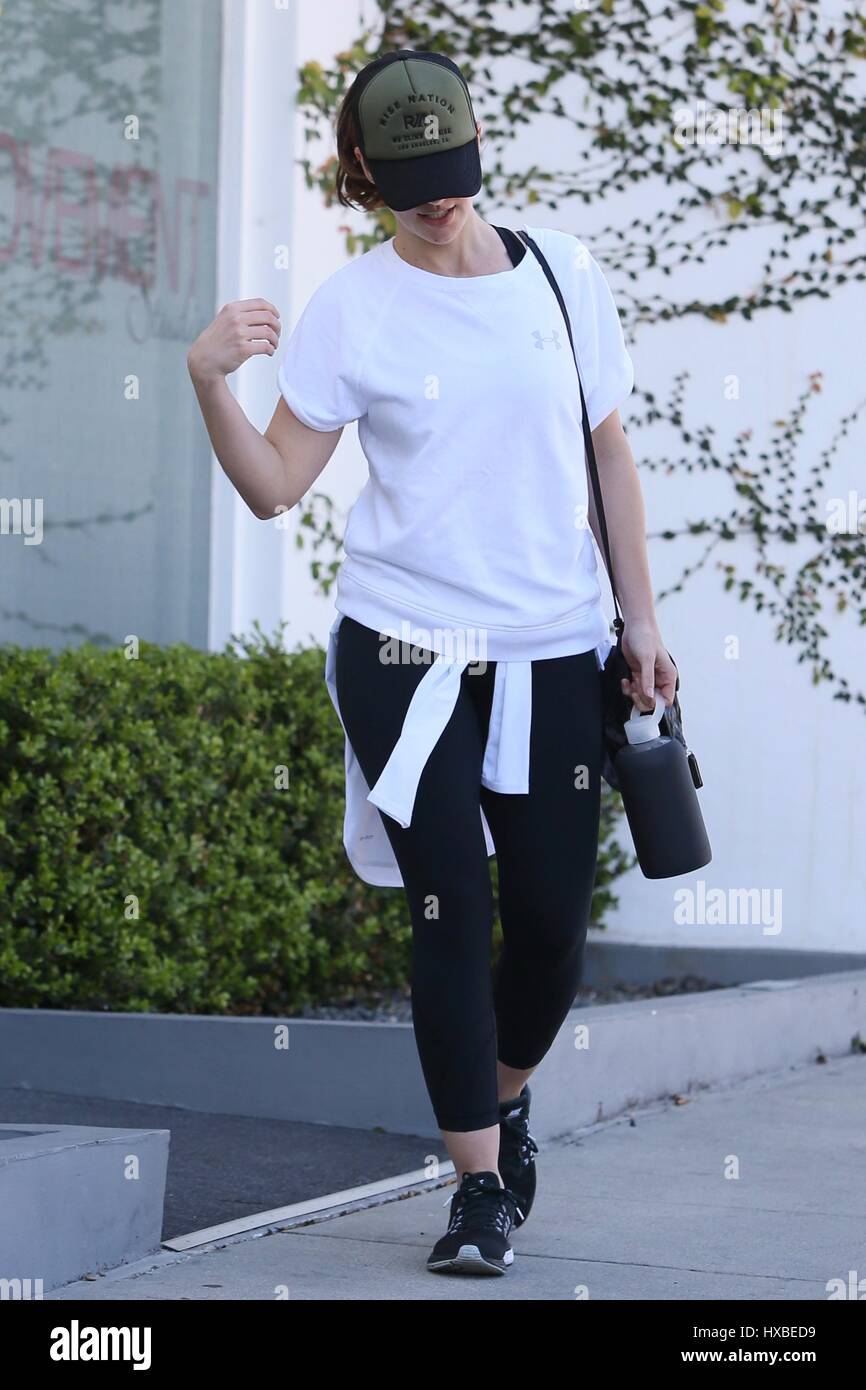 Minka Kelly wears a white tee and black leggings while heading for