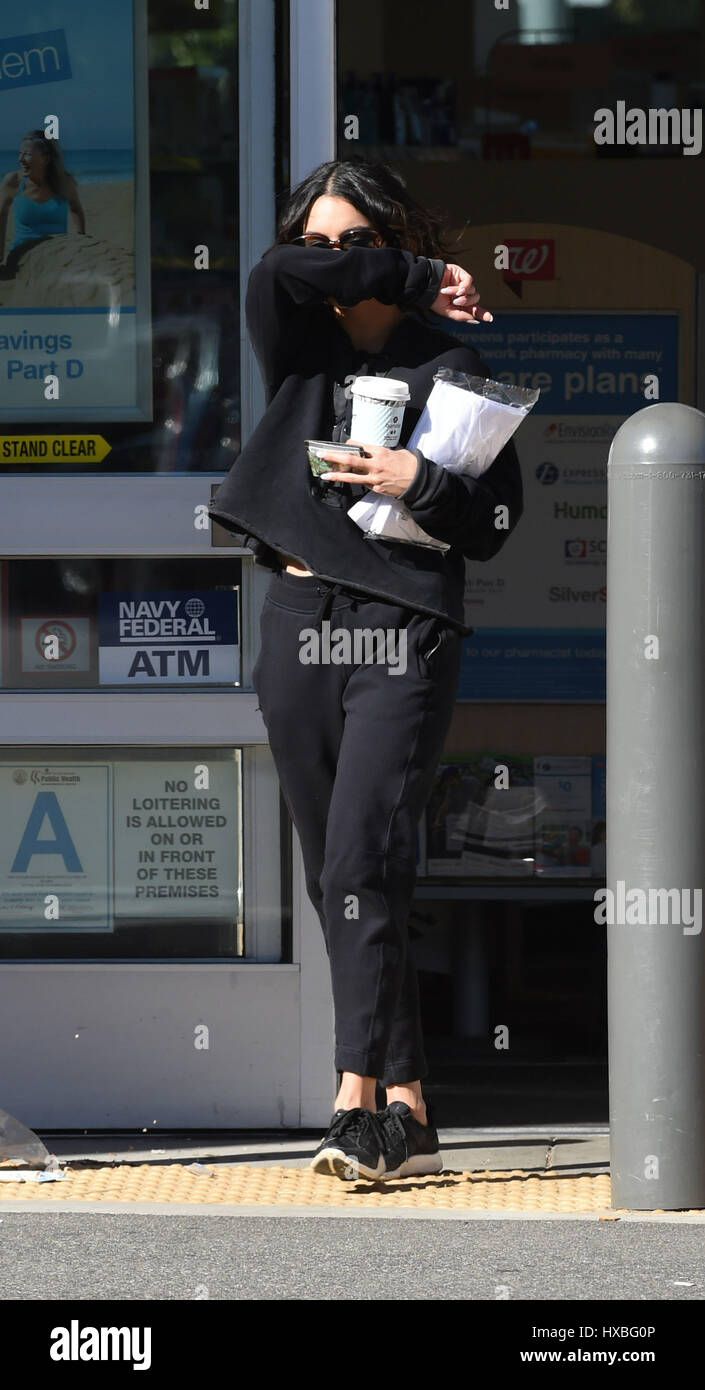 Vanessa Hudgens covers her face coming out of Walgreens Featuring