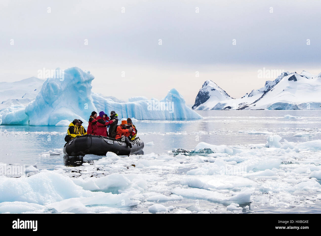Antarctica tourists in Zodiac among Antarctic iceberg. Stock Photo