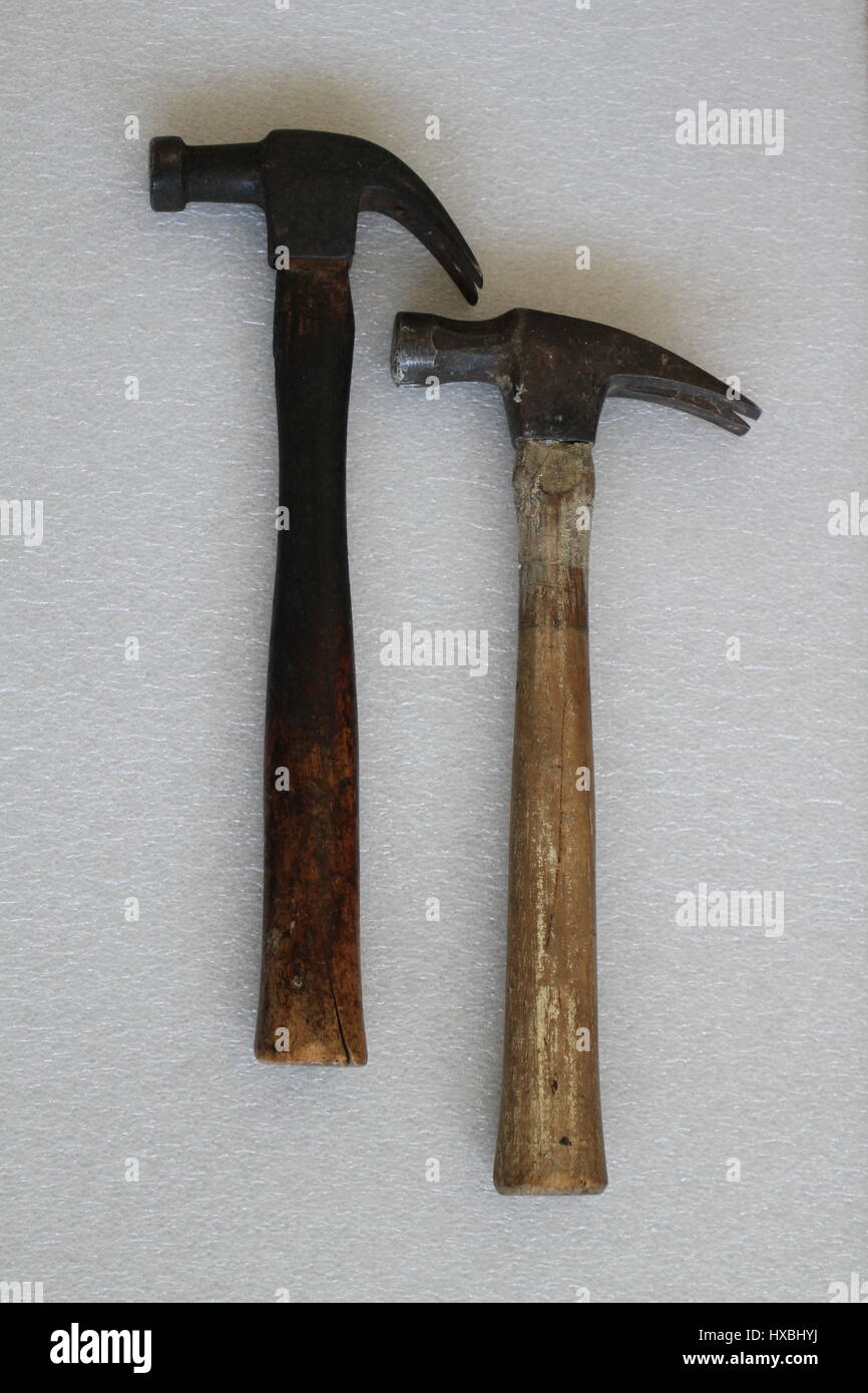 Two iron hammers with a wooden handle lying on a white background. Old hammers are made in the USA. Vertically arranged framing hammers. Retro hammers Stock Photo