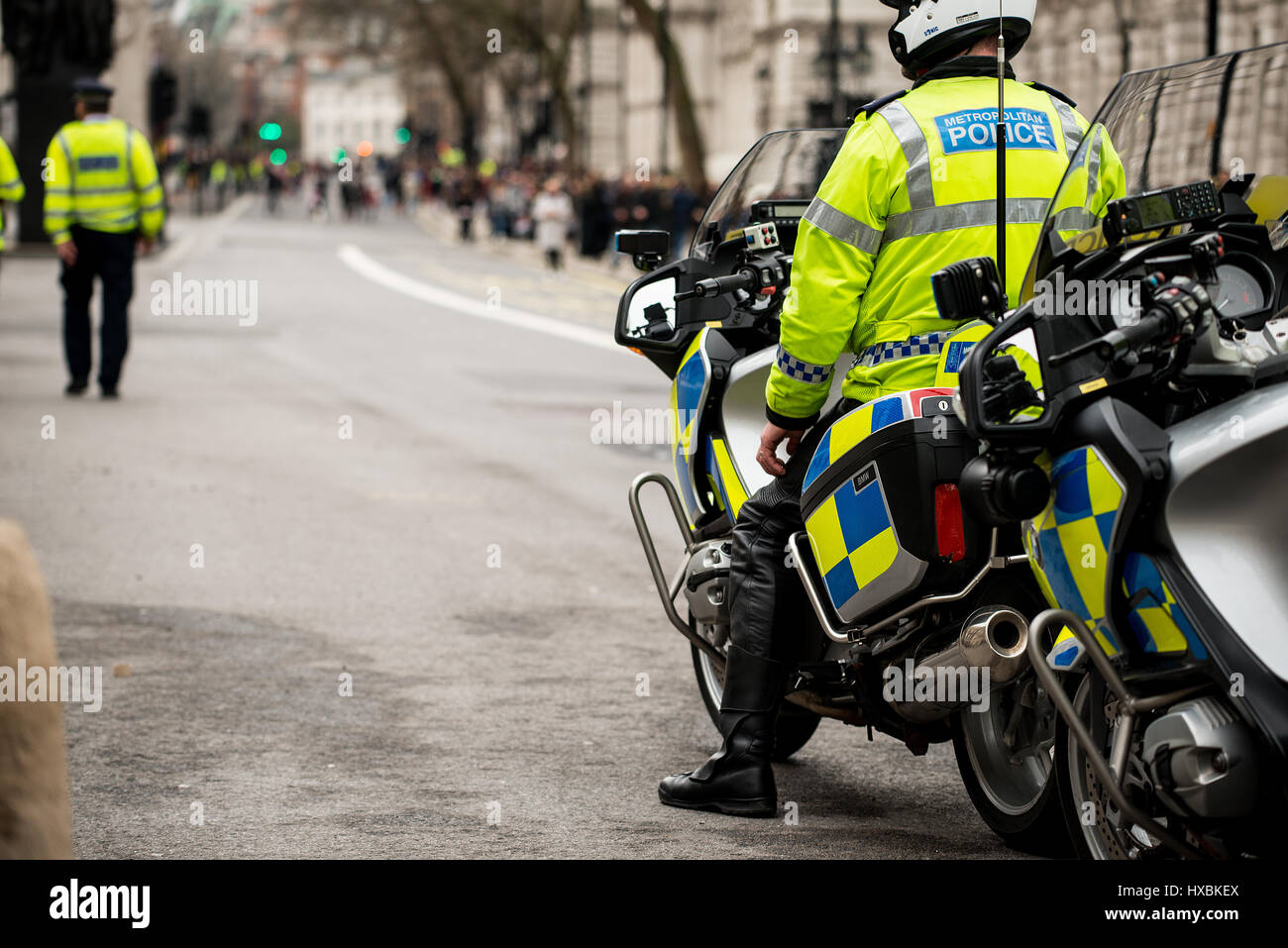 Metropolitan Police officers on motorbikes to ensure public safety and control traffic during a large protest demonstration, in central London,UK. Stock Photo