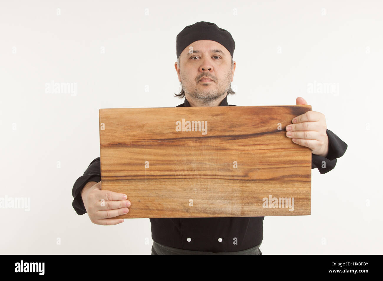 Chef Asian Senior holding wooden cutting board against white background Stock Photo