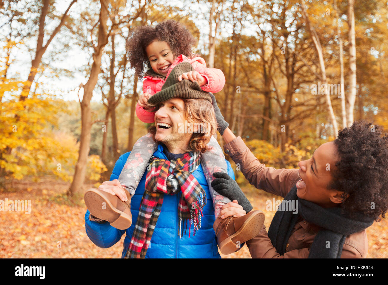 Playful young family in autumn park Stock Photo