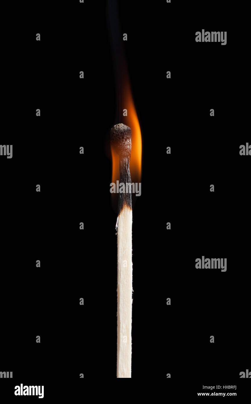 Burning match on black background Stock Photo