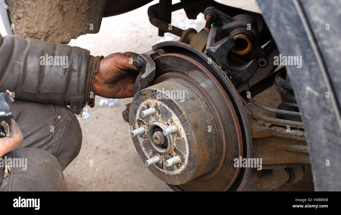 Auto mechanic working on brakes in car repair shop Stock Photo Alamy