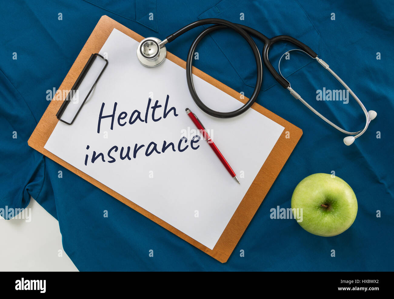 Health insurance Clipboard with stethoscope. Stock Photo