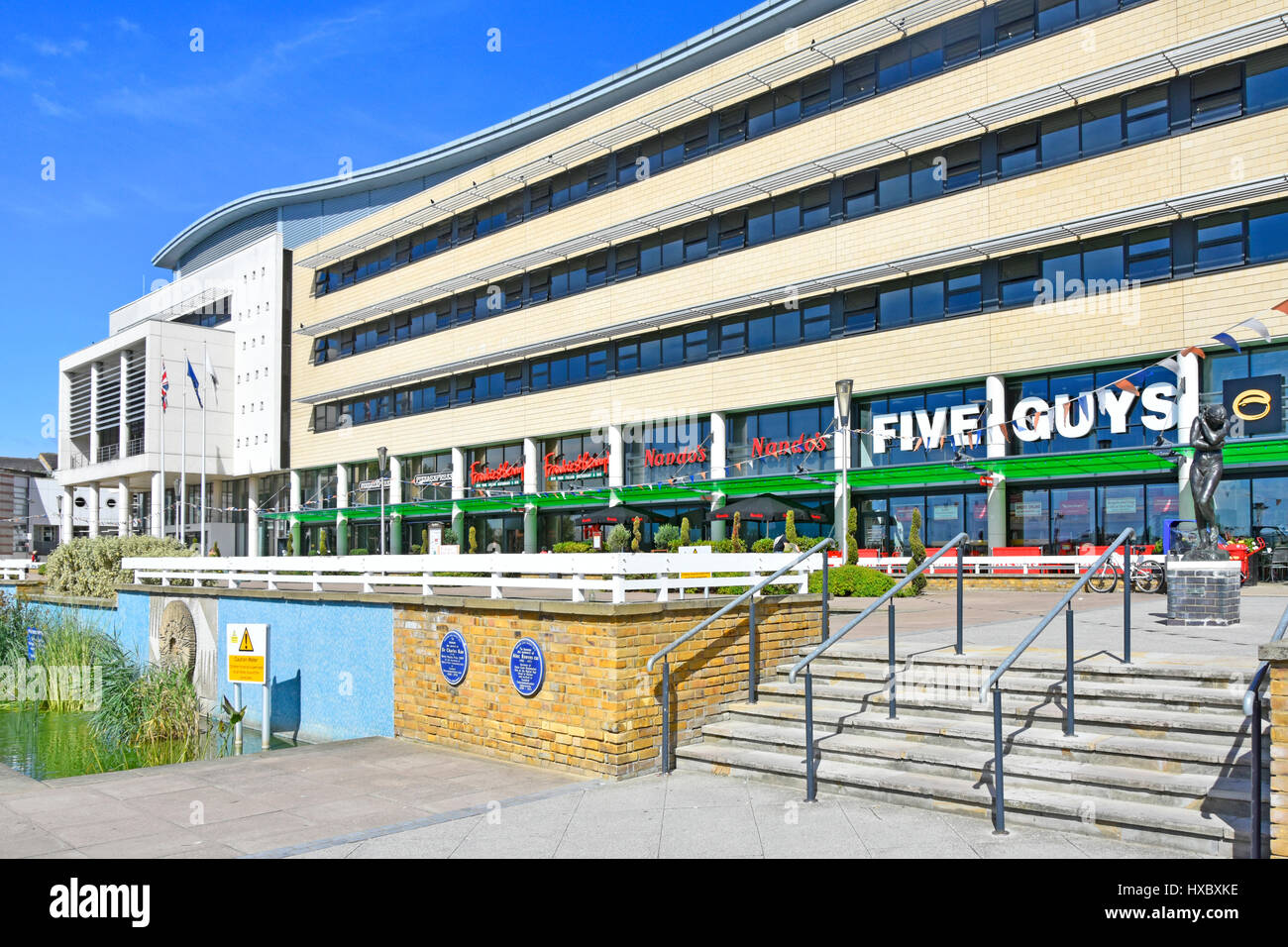 Five Guys Nandos & Pizza Express restaurants fast food business with outdoor eating space at Harlow New Town Civic Centre building Essex England UK Stock Photo